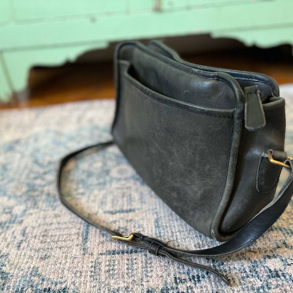 Vintage original medium sized black Coach purse with adjustable strap.